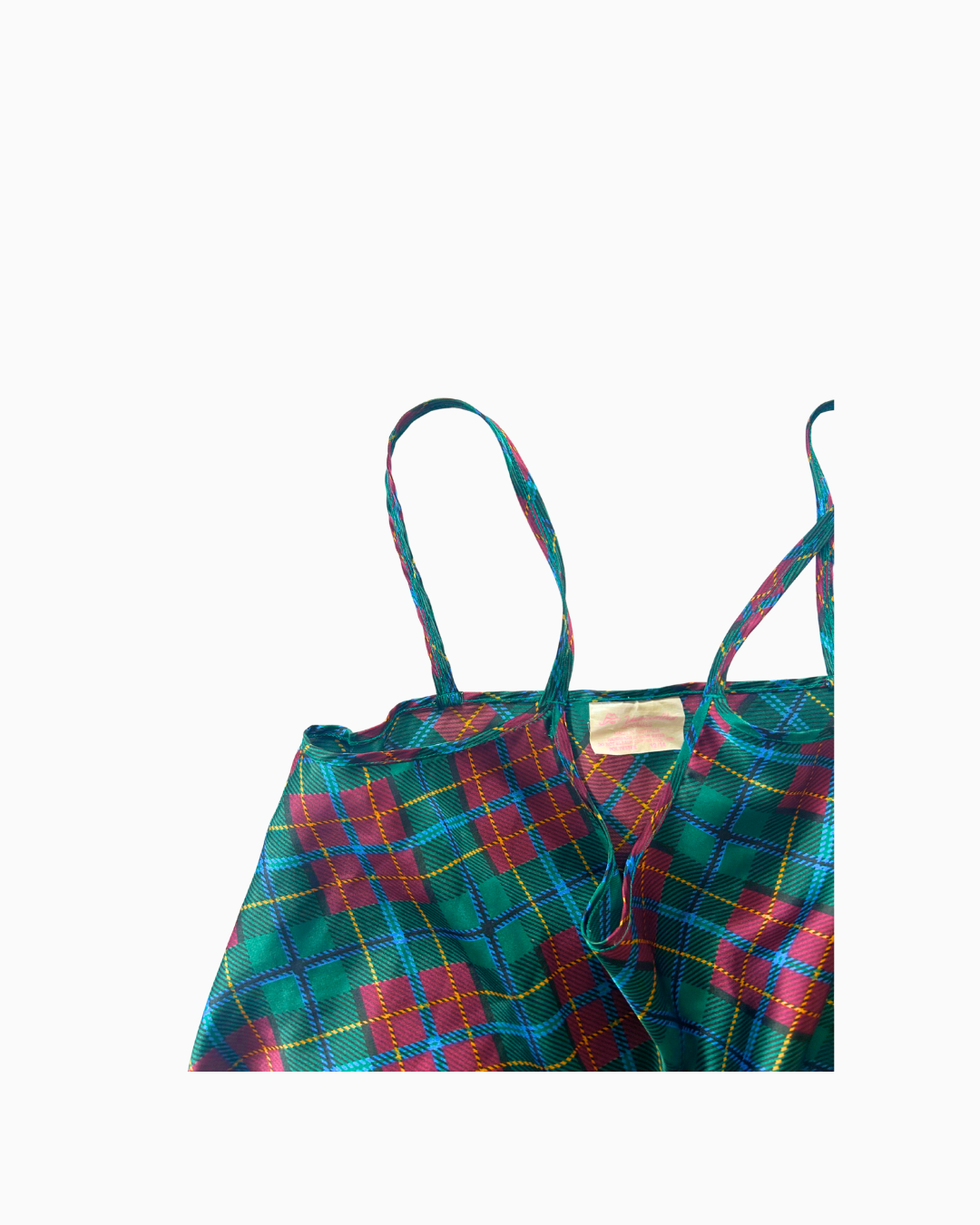 Green plaid dress with thin straps on a white background